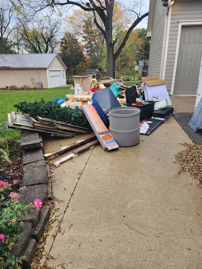 Dumpster being loaded with debris for Roofing Dumpster Rental in Groton